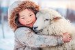 © VisualProduction - Young mongolian girl with sheep. Happy young mongolian girl portrait hugging a sheep in the winter background. Happy asian girl.
