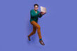 © deagreez - Photo of optimistic nice man office entrepreneur wear stylish clothes running store buy macbook isolated on violet color background