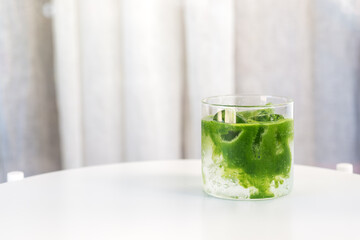 Wall Mural - ice Matcha (green tea) soda refreshing drink on white table