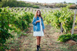 Walking a beautiful woman in a vineyard field