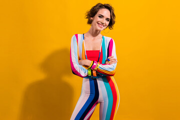 Poster - Photo of positive adorable girl wear trendy bright clothes crossed hands good mood enjoy weekend isolated on yellow color background