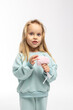 © lara-sh - Portrait of beautiful cute little toddler girl. Child with funny face in mint sweatshirt. Pretty smile kid in studio on white background. High quality photo