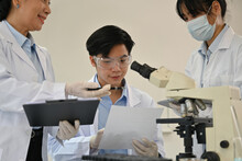 Team Of Scientists Reading Data In Laboratory