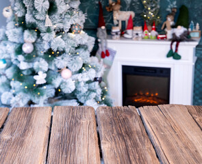 Canvas Print - empty wooden desk Christmas tree and fireplace in the background