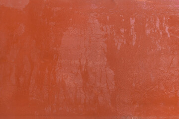  Wet water surface of orange brown leather streaks background texture