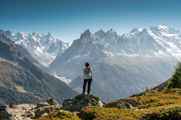 Wall Mural - A female hiker standing with enjoying the Mont Blanc mountain range view during trail in Lac Blanc at France