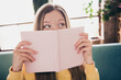 © deagreez - Photo portrait of funny young teenage blonde hair girl in yellow sweater holding open book curious seeing her plans at home on background