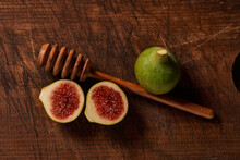 Fresh Figs And Honey Dipper On Aged Wooden Background