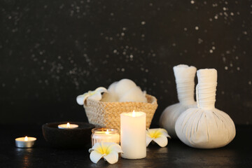 Wall Mural - Spa composition with massage balls, candles and flowers on dark background.