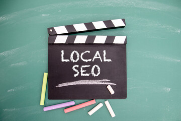 Wall Mural - Local Seo. Movie clapper and colored pieces of chalk