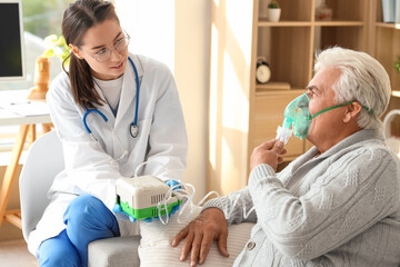 Wall Mural - Senior man with nebulizer and nurse at home