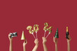 Female hands with champagne bottle, camera and figure 2024 made of balloons on red background