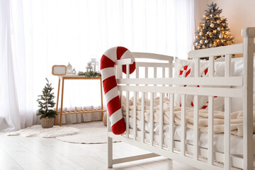 Poster - Baby crib with candy cane pillow in bedroom interior