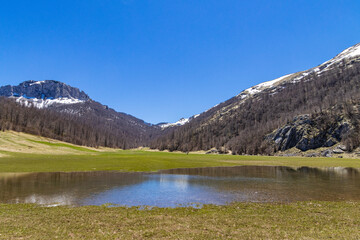 Wall Mural - Mountain lake against clear blue sky