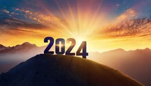 Year 2024, concept. New Year 2024 at sunset. Silhouette 2024 stands on a mountain with sun rays at sunrise, creative idea. 
