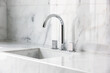 © ADDICTIVE STOCK - Steel faucet with knobs at kitchen sink