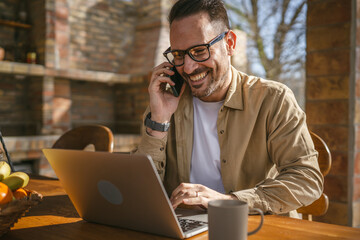 Wall Mural - One adult man in front house in day use smart phone talk make a call