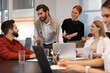 © New Africa - Team of employees working together in office