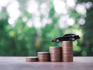 Canvas Print - Close up of toy car on stack coins. The concept of saving money and manage to success transport business