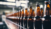 A Brown And Green Beer Bottles On A White Blurred Background Of A Production Line With Copy Space On A White Background.