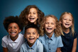 group portrait of happy and smiling children of different races and nationalities isolated on blue background