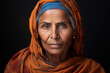 Portrait of a Punjabi elderly wrinkled woman in a traditional costume with a headscarf looking at camera, female nation shot