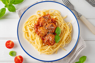 Wall Mural - Traditional Italian spaghetti pasta with meatballs, tomato sauce and parmesan cheese, selective focus. Comfort food.