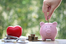 Piggy Bank With Stethoscope And Red Heart On Green Background,Save Money For Medical Insurance And Health Care Concept