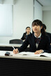 © Paylessimages - 教室で勉強している制服の高校生