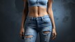 Woman half body wearing stylish light blue jeans on a studio background, close up Free Space for text