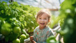 Child with a radiant smile, standing in a greenhouse among lush tomato plants