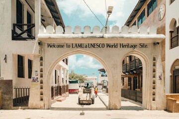 tourists at the entrance of old town lamu in lamu island, kenya