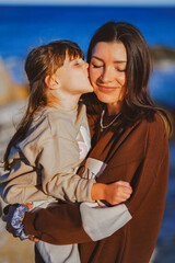 Wall Mural - portrait of a woman with her child on the beach on cyprus