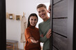 © New Africa - Happy couple welcoming near door. Invitation to come indoors