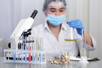 Wall Mural - pistachios on table and scientist proceeding quality control in laboratory