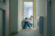 Female doctor assisting and comforting to male patient with mental disorder and suicidal thoughts sitting on the room floor of hallway
