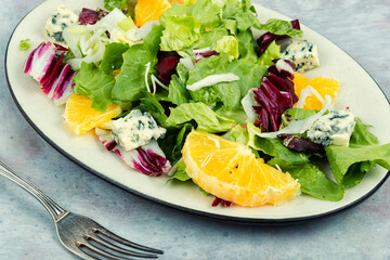 Wall Mural - Colorful salad with herbs and orange.