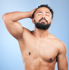 Wall Mural - Shower, cleaning and relax man with shampoo and calm from water, skincare and morning routine. Bathroom, cosmetics and male model in studio with blue background and dermatology for wellness and wash