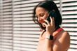 © Vulp - Close up portrait shot of a woman talking on the phone after a good run outdoors.
