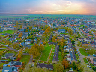 Wall Mural - Aerial from the village Koudum in Friesland the Netherlands at sunset