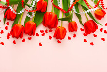 Fresh Red Tulips And Hearts On Pink Background, Concept Of Spring And Holidays Or Valentine's Day, Top View, Copy Space