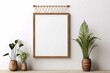 Interior poster mockup with vertical wooden frame on empty white wall decorated with plant branch and hanging macrame pot
