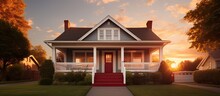 Sunset Behind A Suburban House With Porch Pillars And Red Door