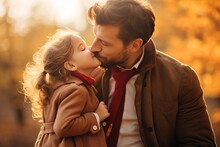 Portrait Father And Daughter Kissing  In Autumn Outdoor