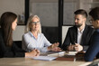 © fizkes - Confident senior business professional woman speaking to colleagues on corporate meeting, giving ideas, solutions for marketing strategy, discussing project management, brainstorming