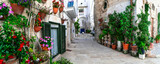 Fototapeta Uliczki - Traditional charming towns of southern Italy in Puglia region - Monopoli old town with floral narrow streets.