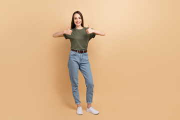 Sticker - Full body size photo of attractive mature happy woman wearing khaki t shirt denim jeans thumbs up sign isolated on beige color background