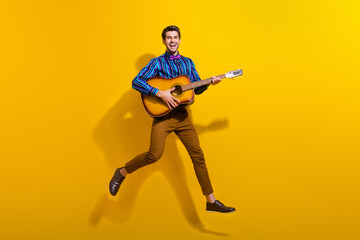 Sticker - Full body photo of funky man wear bow tie stylish shirt flying with guitar in hands singing song isolated on yellow color background