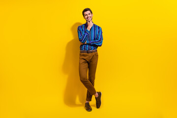 Poster - Full body photo of clever smart man with bristle wear vintage bow tie legs crossed hand on chin isolated on yellow color background