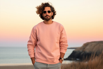 Man wearing a high-quality Flat Blank Plane crewneck Light Pink color Sweatshirt Mockup with oversized look and sunglasses and nature mountain background